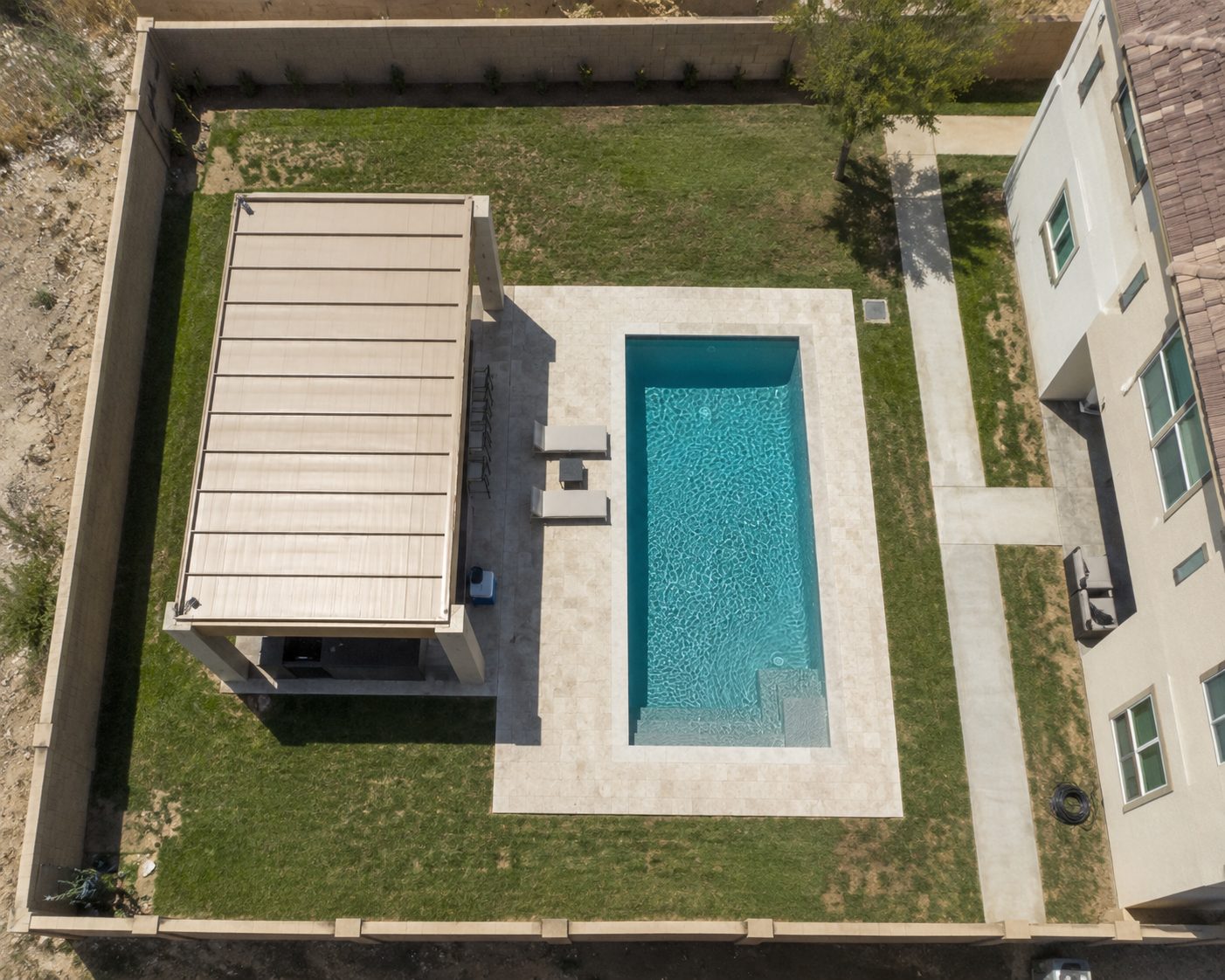 Aerial view of backyard pool and shade pergola