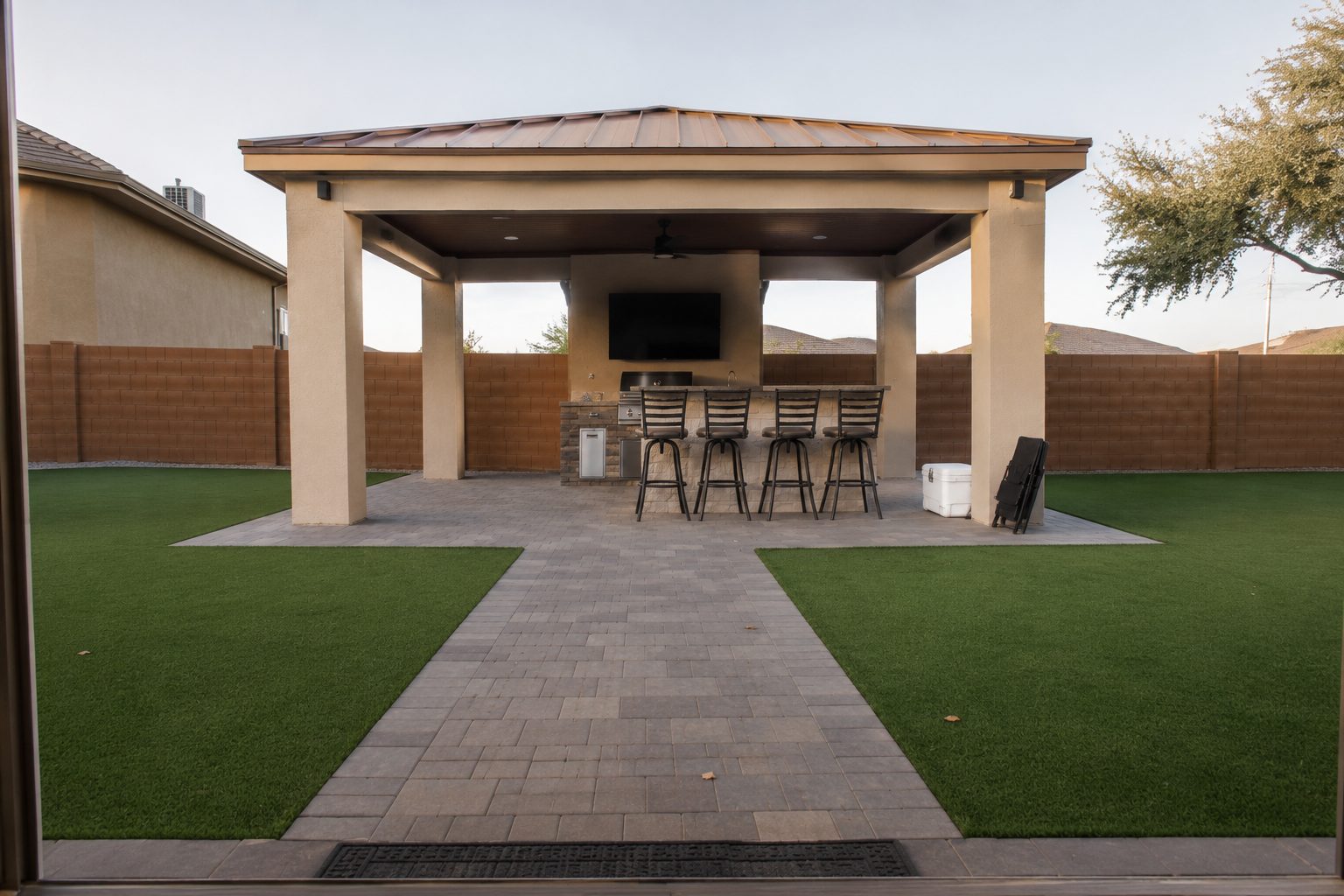 Cabana with outdoor kitchen, bar and synthetic turf yard